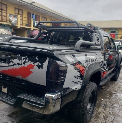 Toyota Tacoma with custom wrap and roll bar